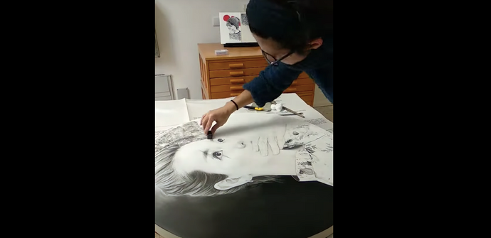 Artist Lantomo working on a new drawing in her studio